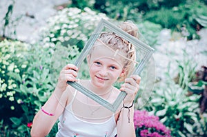 child with empty frame in the hand