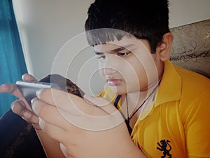 A child engrossed in a mobile gadget