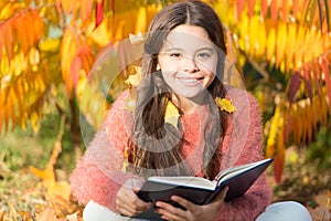 Child enjoy reading. Schoolgirl study. Study every day. Girl read book autumn day. Little child enjoy learning at