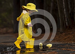 Child Enjoying The Rain In His Galoshes