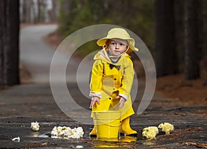 Child Enjoying The Rain In His Galoshes