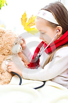 Child is examining her teddy bear