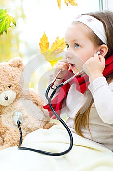 Child is examining her teddy bear