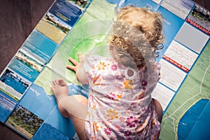 Child exploring map for holiday planning