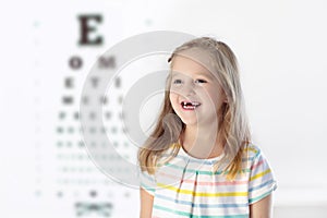 Child at eye sight test. Kid at optitian. Eyewear for kids.