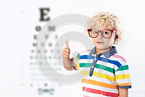 Child at eye sight test. Kid at optitian. Eyewear for kids.