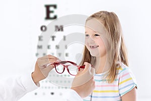 Child at eye sight test. Kid at optitian. Eyewear for kids.