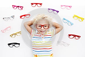 Child at eye sight test. Kid at optitian. Eyewear for kids.