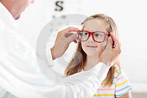 Child at eye sight test. Kid at optitian. Eyewear for kids.