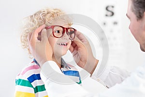 Child at eye sight test. Kid at optitian. Eyewear for kids.