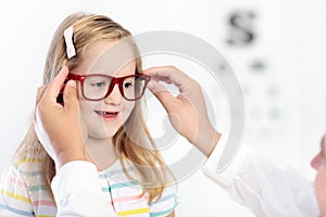 Child at eye sight test. Kid at optitian. Eyewear for kids.