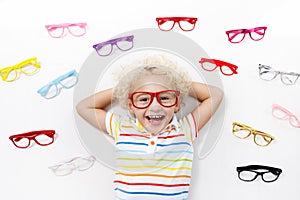 Child at eye sight test. Kid at optitian. Eyewear for kids.