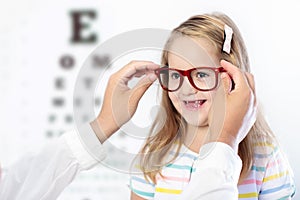 Child at eye sight test. Kid at optitian. Eyewear for kids.