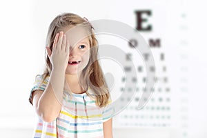 Child at eye sight test. Kid at optitian. Eyewear for kids.