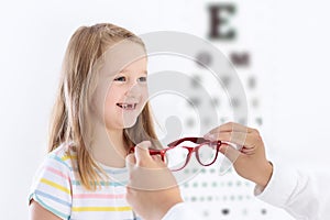 Child at eye sight test. Kid at optitian. Eyewear for kids.