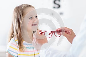 Child at eye sight test. Kid at optitian. Eyewear for kids.