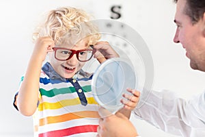 Child at eye sight test. Kid at optitian. Eyewear for kids