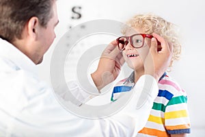 Child at eye sight test. Kid at optitian. Eyewear for kids