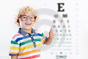 Child at eye sight test. Kid at optitian. Eyewear for kids. photo