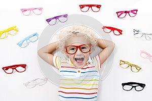 Child at eye sight test. Kid at optitian. Eyewear for kids.