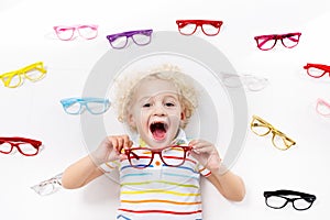 Child at eye sight test. Kid at optitian. Eyewear for kids.