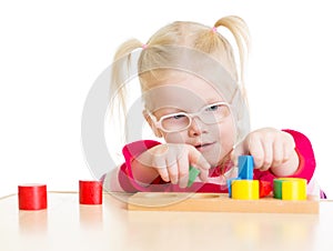 Child in eyeglases playing logical game isolated