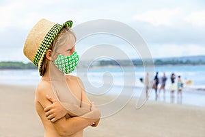 Child in face masks have fun on sea beach