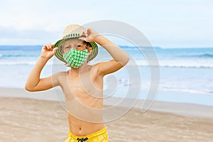 Child in face masks have fun on sea beach