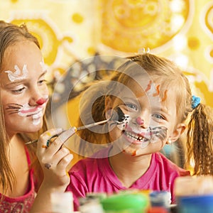 Child with a face painted with colorful paints