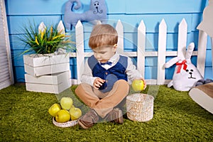 Child on farm picking apples. Cute funny little boy with wicker basket
