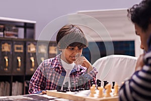 Child, father and chess game with strategy or checkmate move with knight, king or queen. Son, parent and thinking for