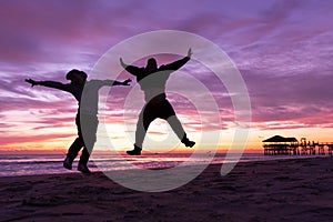 Child and father jumping in the air