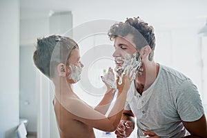 Child, father and learning to shave, smile and bonding together in home bathroom. Happy, dad and teaching kid with