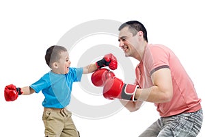 Child and father play with boxing gloves