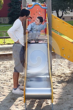 Child and father at playground