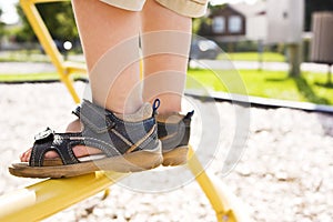 Child feet in a playground