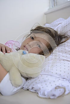 Child with fever in bed