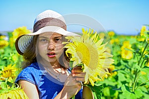 child in field of yellow flowers. teen girl in sunflower field. concept of summer vacation. rich harvest and agriculture