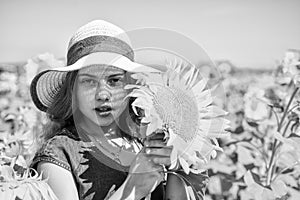 child in field of yellow flowers. teen girl in sunflower field. concept of summer vacation. rich harvest and agriculture