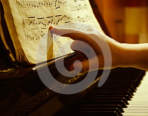 Child finger at music sheet