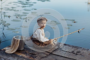 Child fishing at autumn lake