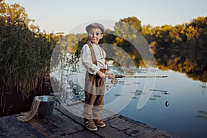 Child fishing at autumn lake