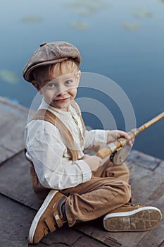 Child fishing at autumn lake