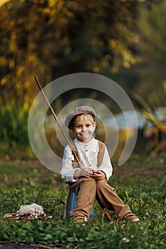 Child fishing at autumn lake