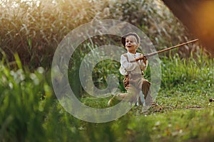 Child fishing at autumn lake