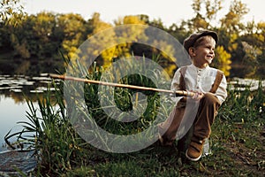 Child fishing at autumn lake