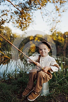 Child fishing at autumn lake