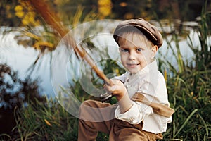 Child fishing at autumn lake