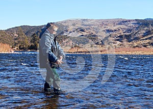 Child fishing - fly fishing in a large river