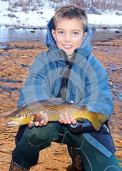 Child fishing - holding a large trout